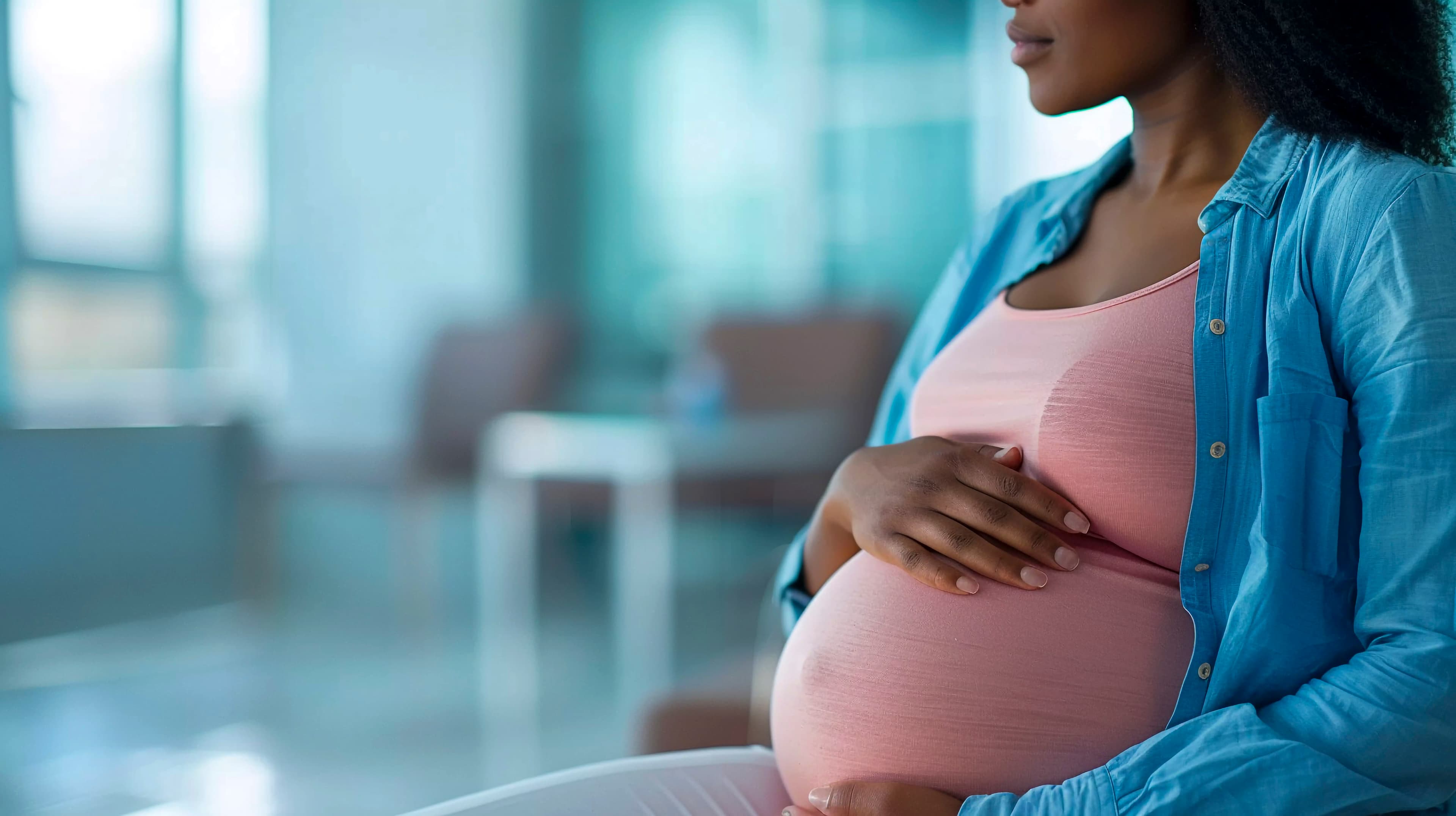 Happy pregnant black woman at home